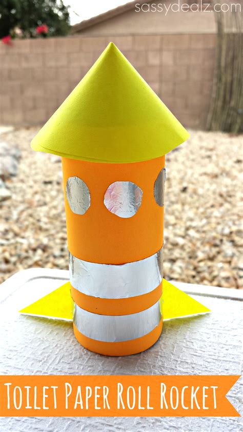 Rocket and rolls - Directions: Cut the white paper using the length of the toilet paper roll to wrap it around it. Cut out a 2" radius circle from the orange paper and wrap it around to make a cone. Cut out three small circles from the yellow paper to make the windows of the rocket. Cut out two small triangles to make the base for the rocket.